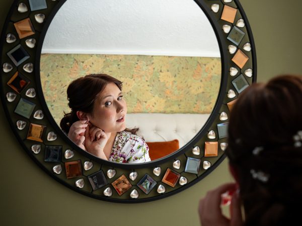 Adam and Abbey’s wedding at Tottington Manor – bride reflected in a mosaic mirror