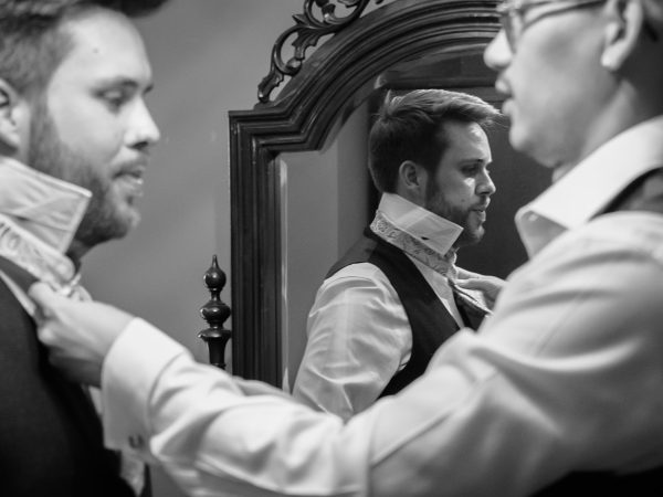 Adam and Abbey’s wedding at Tottington Manor – groom having his cravat tied