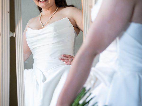 Adam and Abbey’s wedding at Tottington Manor – bride smiling in the mirror