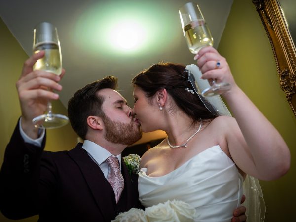 Adam and Abbey’s wedding at Tottington Manor – champagne toast and kiss