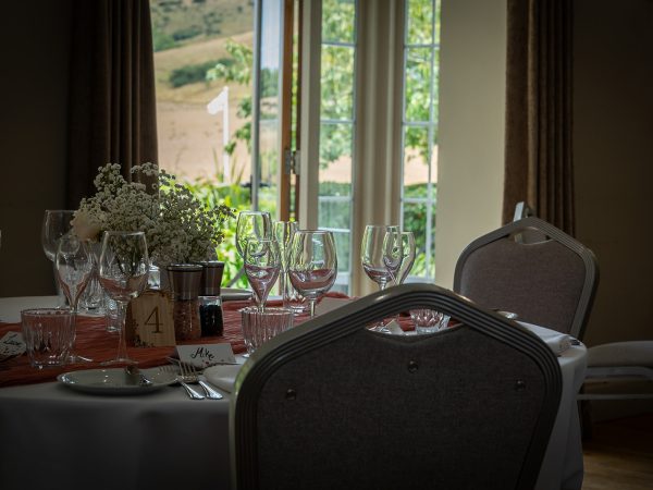 Adam and Abbey’s wedding at Tottington Manor – wedding breakfast table with a view of the Downs