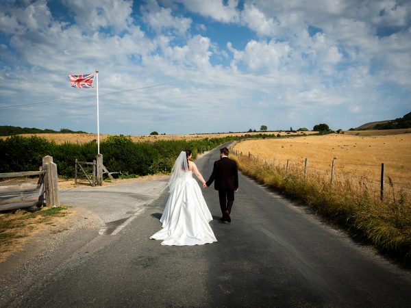 Adam and Abbey’s wedding at Tottington Manor – couple walking down a country lane