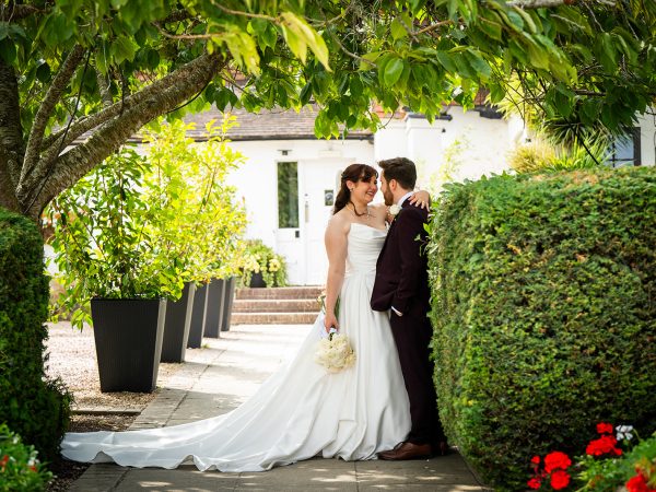 Adam and Abbey’s wedding at Tottington Manor – couple under the trees in the garden