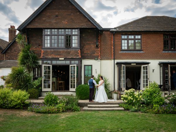 Adam and Abbey’s wedding at Tottington Manor – couple in front of the manor house