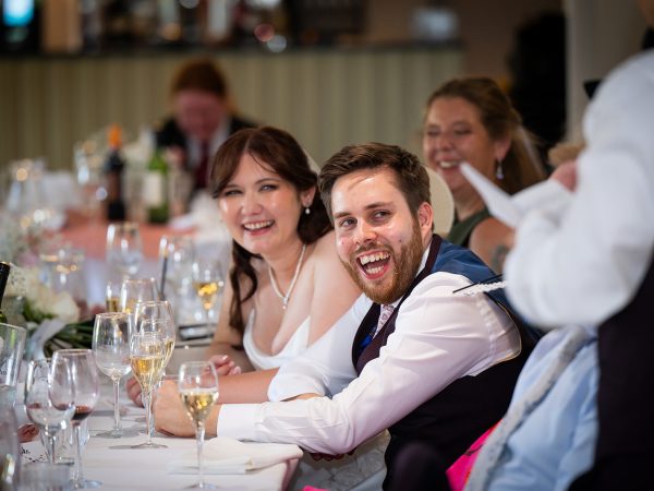 Adam and Abbey’s wedding at Tottington Manor – couple enjoying the speeches