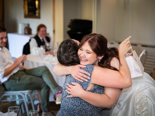 Adam and Abbey’s wedding at Tottington Manor – bride hugging a guest