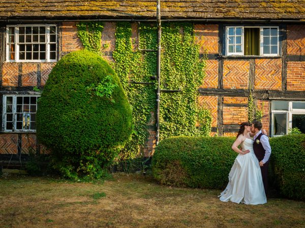 Adam and Abbey’s wedding at Tottington Manor – couple outside the timbered manor house