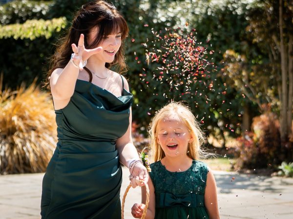 Holly and Andy’s wedding at Field Place – bridesmaid and flower girl smiling at the guests