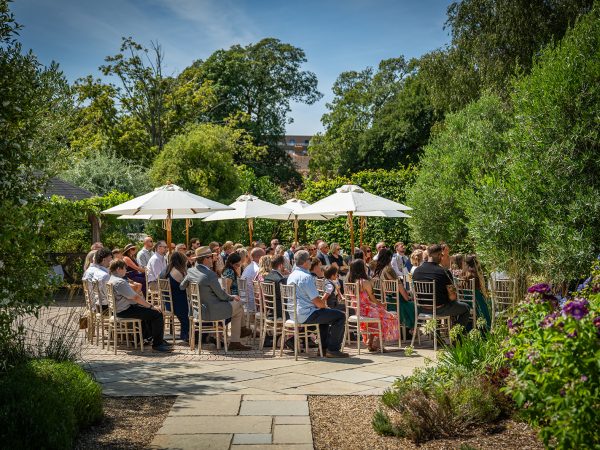 Holly and Andy’s wedding at Field Place – guests gathered for the garden ceremony