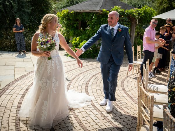 Holly and Andy’s wedding at Field Place – newlyweds walking back down the aisle