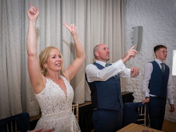 Holly and Andy’s wedding at Field Place – bride with her arms in the air