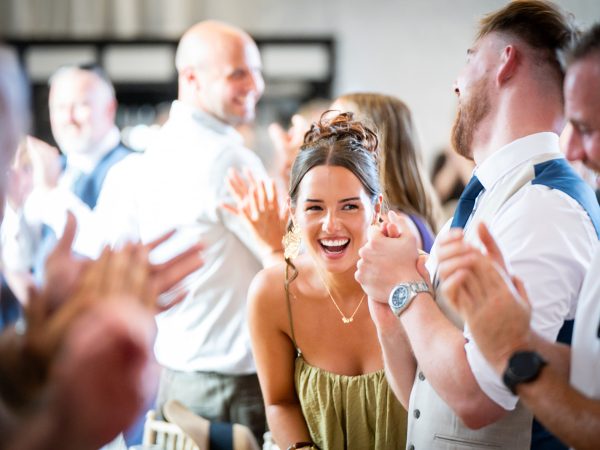 Holly and Andy’s wedding at Field Place – guest laughing at the reception