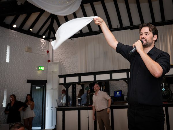 Holly and Andy’s wedding at Field Place – singing waiter waving a napkin