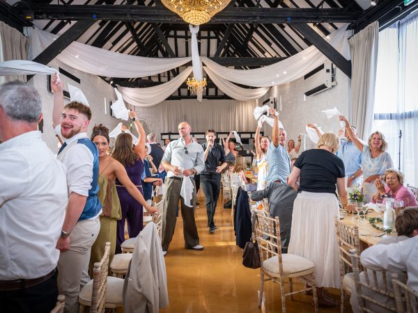 Holly and Andy’s wedding at Field Place – guests waving napkins