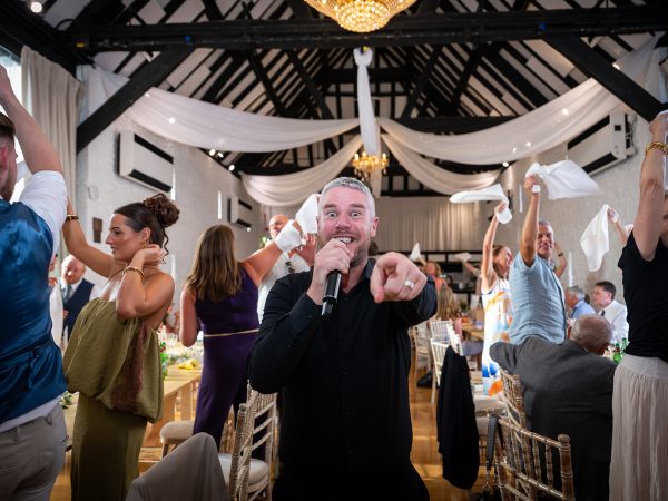 Holly and Andy’s wedding at Field Place – singing waiters in the barn
