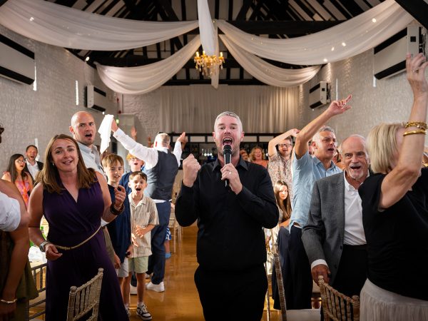 Holly and Andy’s wedding at Field Place – the whole room waving napkins