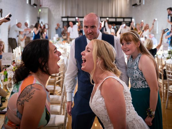 Holly and Andy’s wedding at Field Place – bride laughing with guests