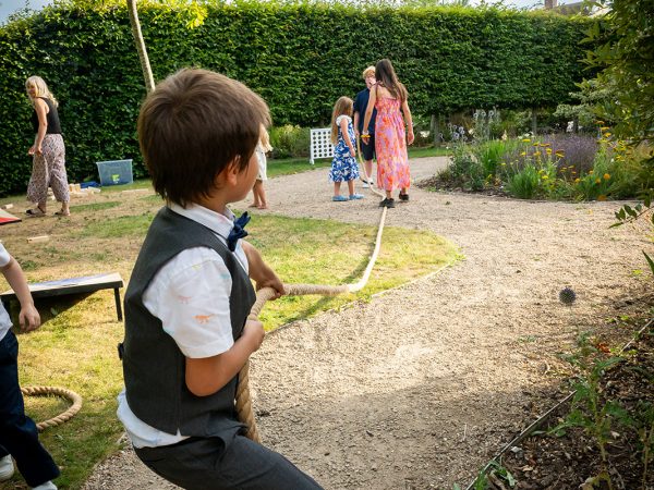 Holly and Andy’s wedding at Field Place – young guest playing in the garden