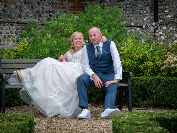 Holly and Andy’s wedding at Field Place – bride and groom on a garden bench