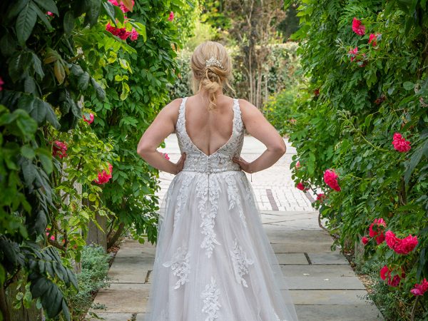 Holly and Andy’s wedding at Field Place – bride under the rose arch