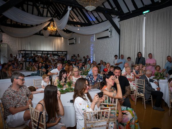 Holly and Andy’s wedding at Field Place – guests in the barn for the speeches