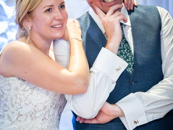 Holly and Andy’s wedding at Field Place – bride and groom listening to the speeches