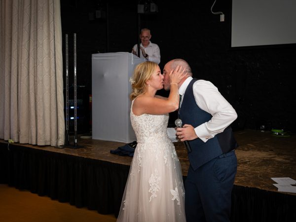 Holly and Andy’s wedding at Field Place – a kiss after the speeches